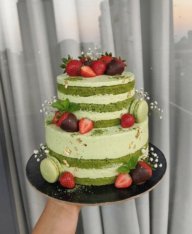 Matcha birthday cake with strawberries and macarons